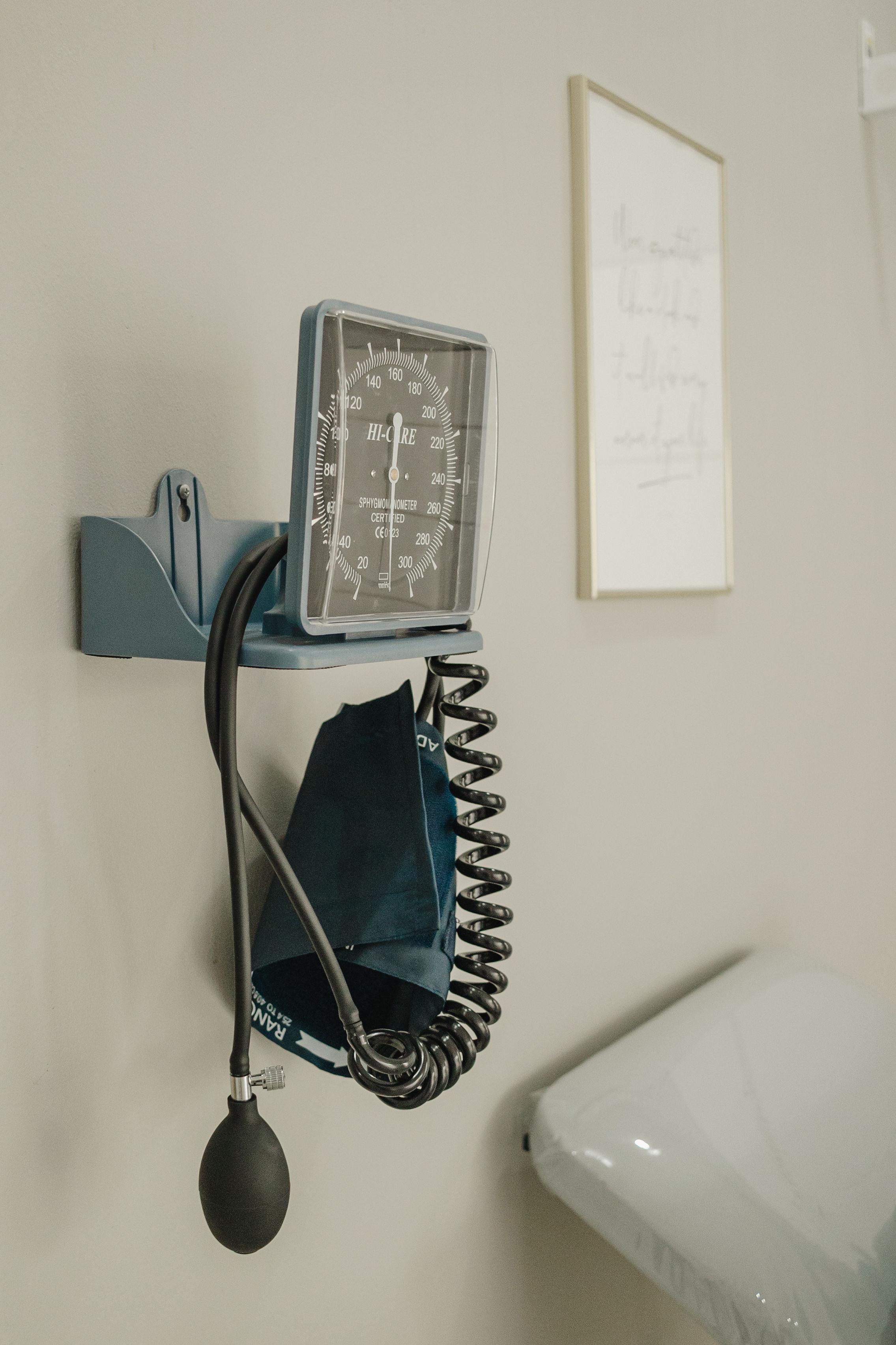 Blood pressure monitor mounted in a consultation room at the practice